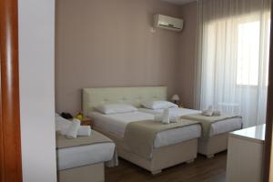 Postel nebo postele na pokoji v ubytování Signature Idea hotel