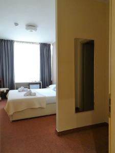 Postel nebo postele na pokoji v ubytování Signature Idea hotel