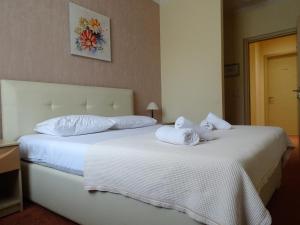 Postel nebo postele na pokoji v ubytování Signature Idea hotel