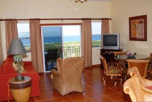 a living room with a view of the ocean at Ocean Terrace Condominiums in The Valley