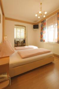 een slaapkamer met een groot bed en een tafel bij Hotel Tautermann in Innsbruck