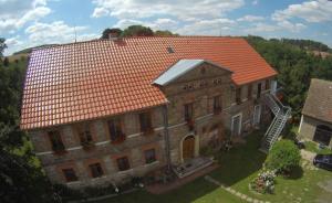 a large brick building with an orange roof at POLANA in Leśna
