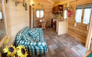 a living room of a tiny house with a couch at CHALET ETNA MILO in Milo