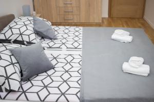 a bedroom with a bed with towels on it at City Break Apartment in Visoko +43 photos