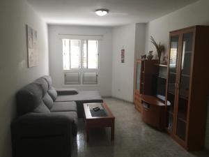 a living room with a couch and a coffee table at Apartamento Los Llanos 1-L1 in Vecindario