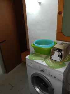 a washing machine with a bowl on top of it at BILOCALE VERDI A C/MARE GOLFO in Castellammare del Golfo