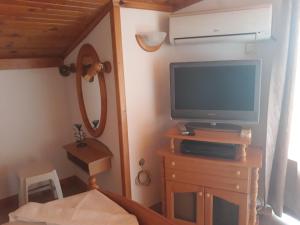 a room with a tv on a dresser with a tvictericter at Dom Shtakovi in Pomorie
