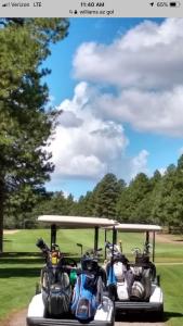 two motorcycles on a golf cart at a golf course at Highlander Motel in Williams