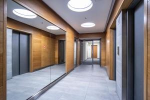 a hallway of an office building with lights on the ceiling at Dworzec Gdański Apartament in Warsaw