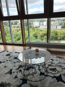 a coffee table in a room with a large window at Dworzec Gdański Apartament in Warsaw