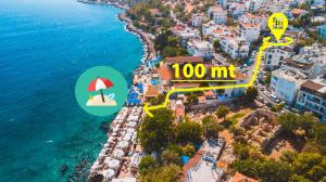 an aerial view of a beach with an umbrella and the ocean at Hotel Sonne - Adults Only in Kaş