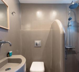 a bathroom with a sink and a toilet and a shower at Andros Blue in Andros