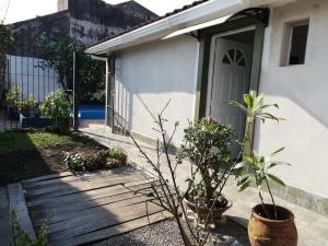 a house with a wooden pathway leading to a door at Don Carlos Apart in San Miguel de Tucumán