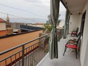 a balcony with chairs and a view of the city at Apartment Marina in Senj