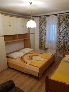 a bedroom with a large bed and a chandelier at Apartment Marina in Senj +8 photos