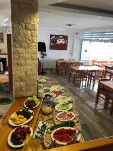a table with many plates of food on it at Rain Hotel in Kizkalesi