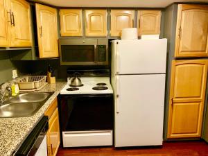 a kitchen with a white refrigerator and a stove at Desert Getaway in Desert Hot Springs
