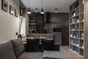 a living room with a couch and a kitchen at S7 Apartment in Riga