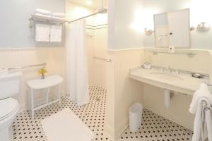 Baño blanco con lavabo y aseo en The Springwater Bed and Breakfast, en Saratoga Springs