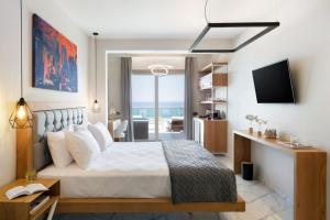 a bedroom with a large bed with a view of the ocean at Sea Level Hotel - Adults Only 16 plus in Polychrono