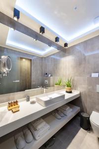 a bathroom with a sink and a mirror at Sea Level Hotel - Adults Only 16 plus in Polychrono