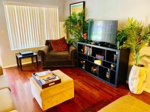 a living room with a couch and a tv at Desert Getaway in Desert Hot Springs