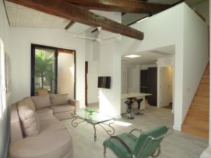 a living room with a couch and a glass table at Loft Appartement Vacances in Pinet