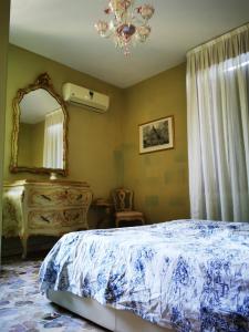 a bedroom with a bed and a mirror at Cà ARIVANLIAL Venice villa apartament in Venice-Lido