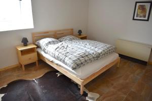 a bedroom with a bed with a comforter on it at Ferienhof Uckermark am Oberuckersee in Suckow