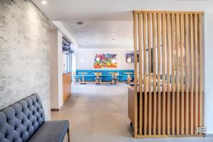 a living room with a blue couch and chairs at Senso Suites in Nea Peramos
