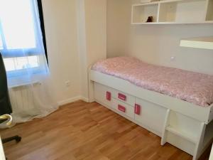 a small bedroom with a bed and a window at Roxy 1 in Ávila