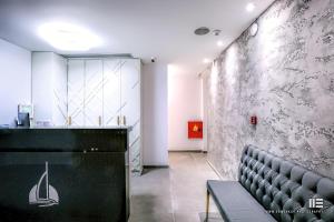 a waiting room with a bench and a counter at Senso Suites in Nea Peramos