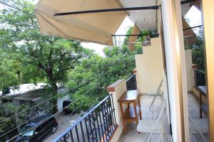 a balcony with a table and an umbrella at Zona Romántica Casa Las Magnolias in Puerto Vallarta