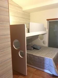 a bedroom with a bed and a white shelf at Penthouse Ria in Santa Luzia +37 photos