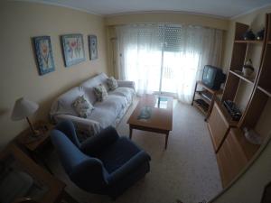 a living room with a couch and a table at Apartamento La Florida en Playa de Gandía in Playa de Gandia