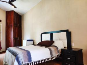 a bedroom with a large bed and a dresser at Habitación Hansa in Puerto Vallarta