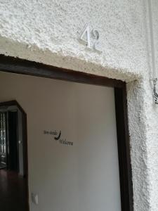 a white garage door with the number on it at Casal Mala-Posta in Rio Maior