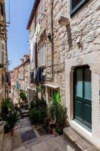 an alley in an old town with plants at OLD TOWN LEA in Dubrovnik