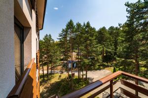 a balcony with a view of the woods at LUX apartman u vili Pekovic in Zlatibor