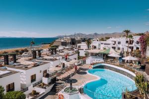 an aerial view of a resort with a swimming pool and the ocean at Apartamentos Moraña in Puerto del Carmen