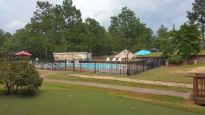 a swimming pool with a tent and a swimming pool at Carolina Pine Inn near Southern Pines-Pinehurst in Pinebluff