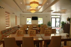 a conference room with tables and chairs and a tv at Khách sạn Hải Quân - The Marine Hotel in Ha Long