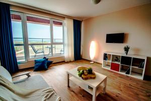 a living room with a view of the ocean at Zornitsa Apart in Primorsko