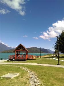 a gazebo on the shore of a lake at Cabaña la Vega in Hornopiren
