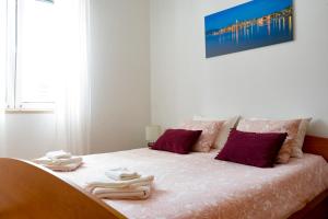 a bedroom with a bed with towels on it at Apartment Rose in Korčula