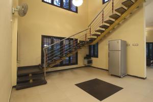 an empty room with a spiral staircase in a building at Temple Tree Residence in Yelagiri