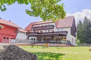 un grand bâtiment avec une terrasse sur son côté dans l'établissement Tanzbuche, à Friedrichroda