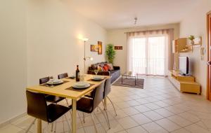 a dining room and living room with a table and chairs at Spacious, Top Location Sliema Apartment in Sliema
