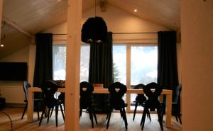 a dining room with a table and chairs and a window at MO Chalet in Gaschurn
