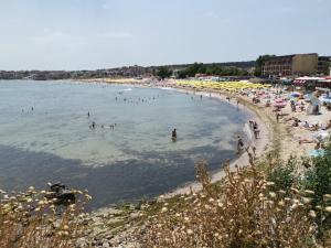 a group of people swimming in the water at a beach at Hotel Briz in Sozopol